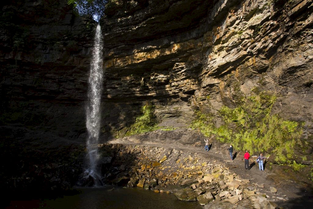 The image shows Hawdraw Force, England's highest single drop waterfall, in North Yorkshire. Its a perfect place for a dog walk when staying at Yorebridge House.