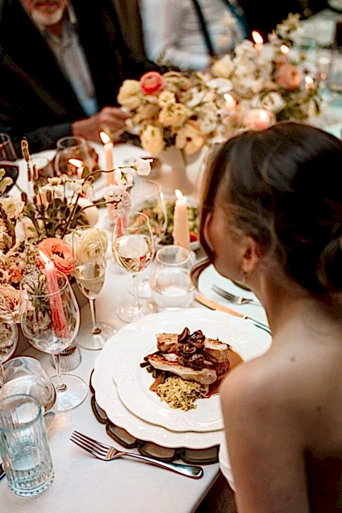 The image shows a bride at her wedding breakfast in the Orangery of Yorebridge House Hotel for a wedding in North Yorkshire.