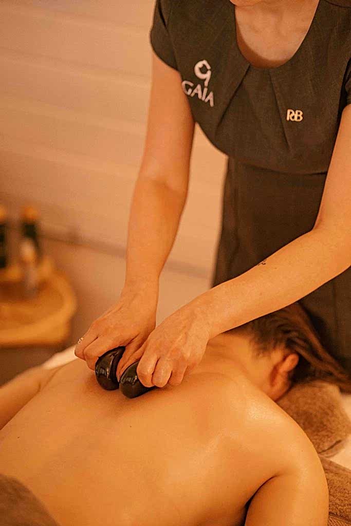 The image shows the treatment room at Ure River Retreat spa facilities at Yorebridge House Hotel in North Yorkshire. The customer is getting a massage from the spa therapist. The Ure River Retreat is nestled in the Yorkshire Dales and sits beside the River Ure.