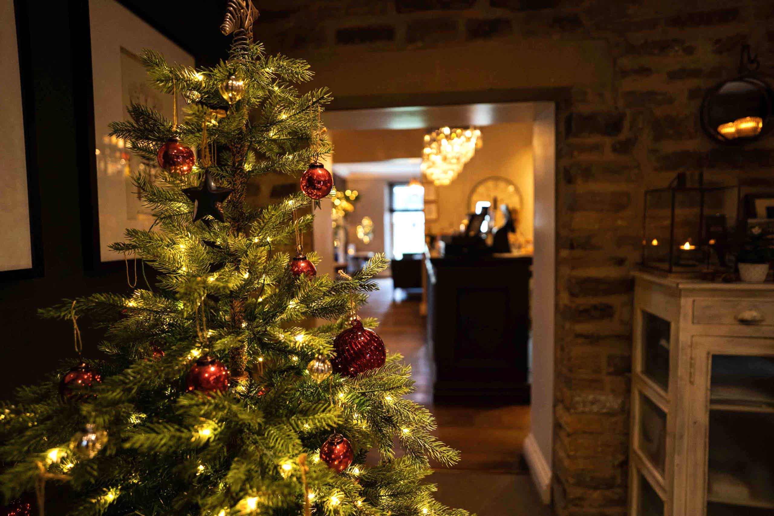 The image shows the Christmas tree at Yorebridge House hotel in North Yorkshire. Their Christmas hotel packages are designed to allow guests a festive break in the Yorkshire Dales where everything is taken care of and they can simply relax and enjoy.